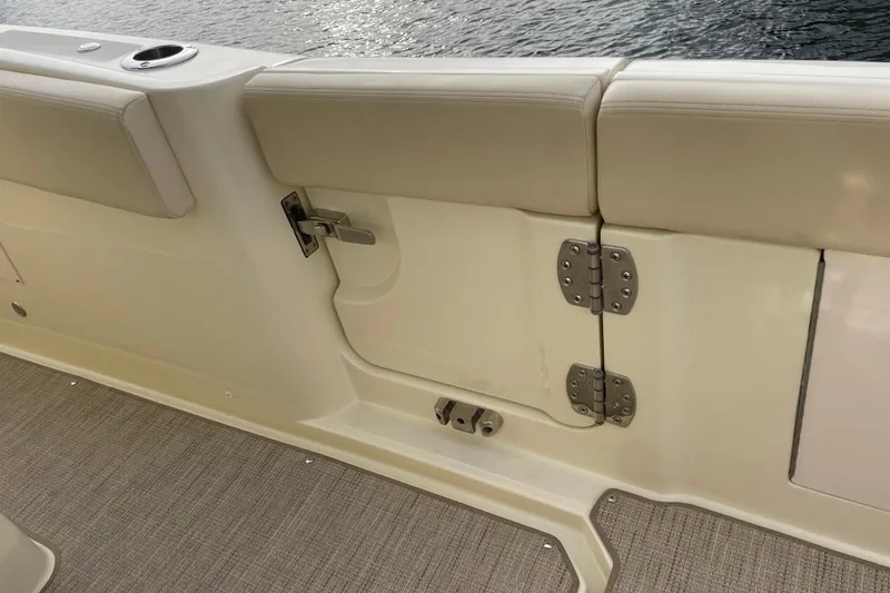 Slide: The Image of 2026 Chris-Craft 310 Catalina boat interior with beige seating and stainless steel hardware. - 35