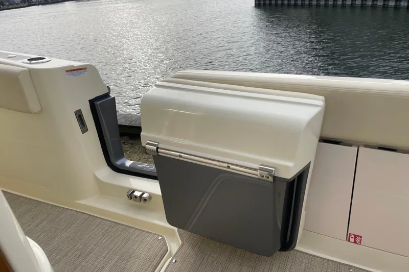 Slide: The Image of 2026 Chris-Craft 310 Catalina boat interior with water view, featuring a sleek storage compartment. - 36