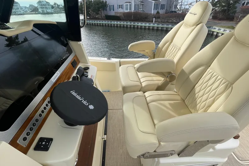 Slide: The Image of Luxurious interior of 2026 Chris-Craft 310 Catalina boat with plush seating and modern dashboard. - 38