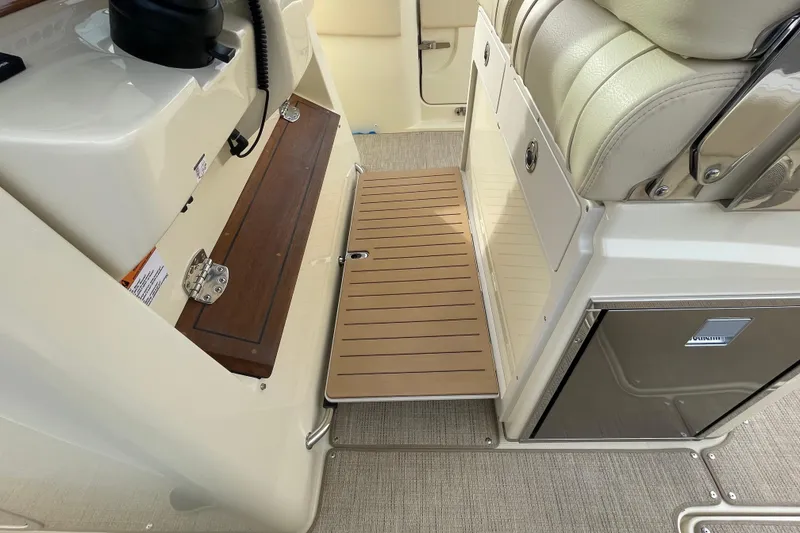 Slide: The Image of 2026 Chris-Craft 310 Catalina interior with wooden step and cushioned seating. - 41