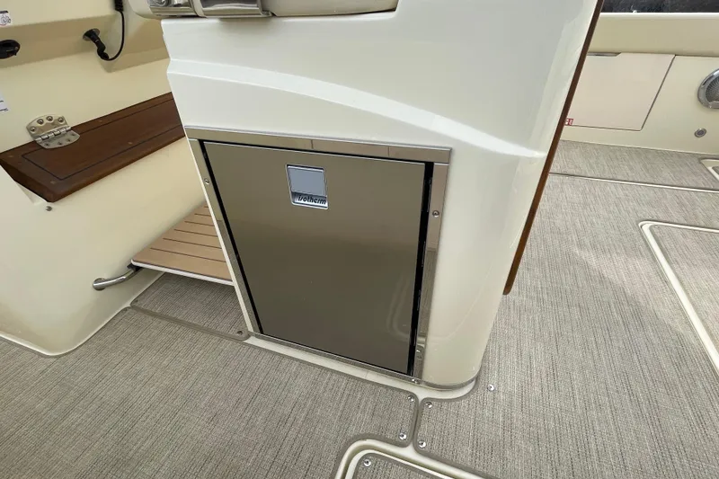 Slide: The Image of 2026 Chris-Craft 310 Catalina interior with stainless steel cabinet and wooden accents. - 42