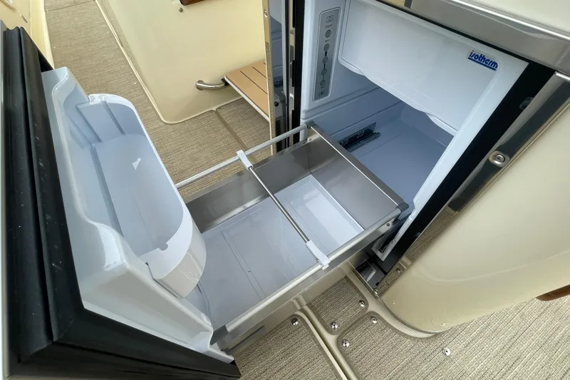 Slide: The Image of 2026 Chris-Craft 310 Catalina boat refrigerator with open drawers, showcasing modern design. - 43
