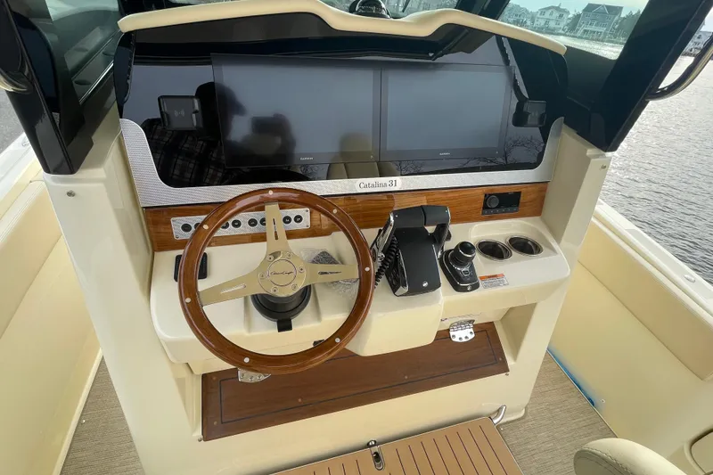 Slide: The Image of 2026 Chris-Craft 310 Catalina helm with wooden steering wheel and modern controls. - 46