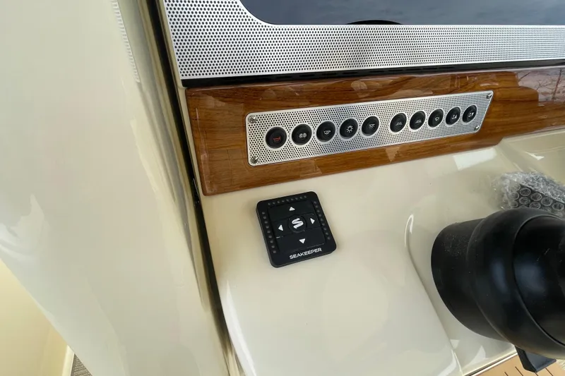 Slide: The Image of 2026 Chris-Craft 310 Catalina dashboard with Seakeeper control and sleek wood paneling. - 47