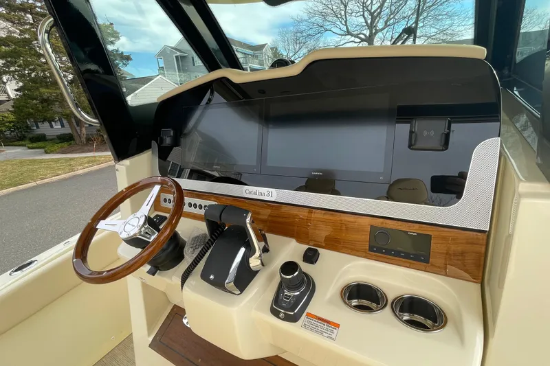 Slide: The Image of 2026 Chris-Craft 310 Catalina helm with modern controls and wood accents. - 48