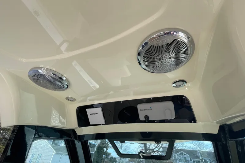 Slide: The Image of 2026 Chris-Craft 310 Catalina interior with speakers and Garmin navigation system. - 49