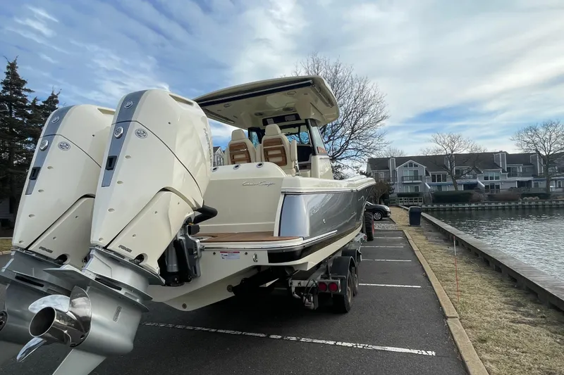 Slide: The Image of 2026 Chris-Craft 310 Catalina boat on trailer by waterfront homes. - 5