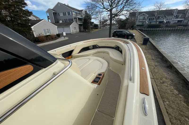 Slide: The Image of 2026 Chris-Craft 310 Catalina boat docked near waterfront homes, showcasing elegant design. - 53