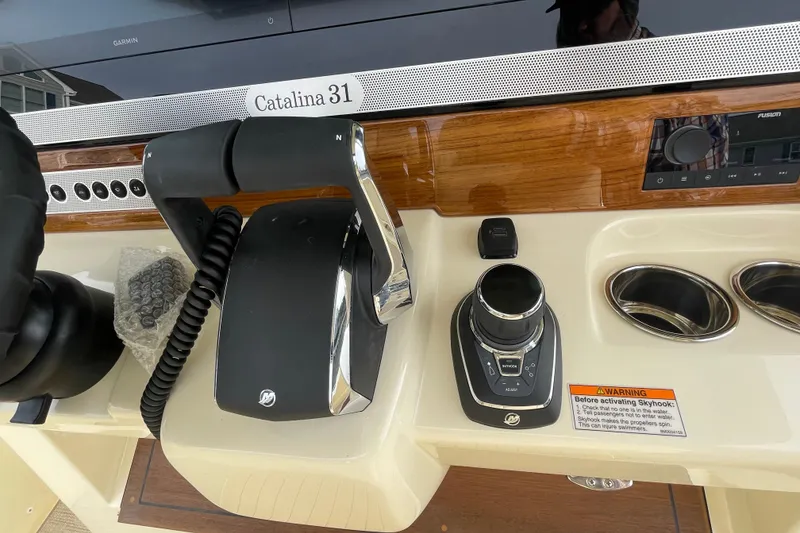 Slide: The Image of 2026 Chris-Craft 310 Catalina helm controls with joystick and throttle levers. - 58