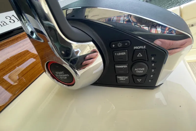 Slide: The Image of Control panel of 2026 Chris-Craft 310 Catalina boat with start/stop button and trim settings. - 59