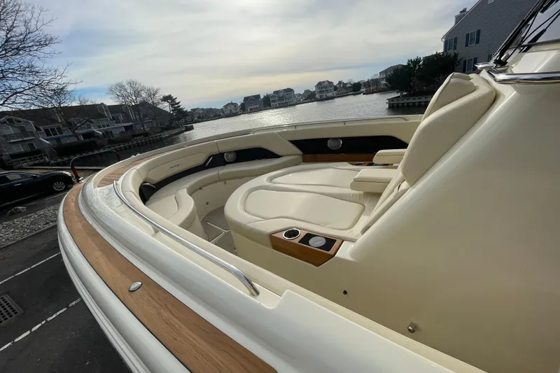 Slide: The Image of 2026 Chris-Craft 310 Catalina boat with luxurious seating, docked by waterfront homes. - 65