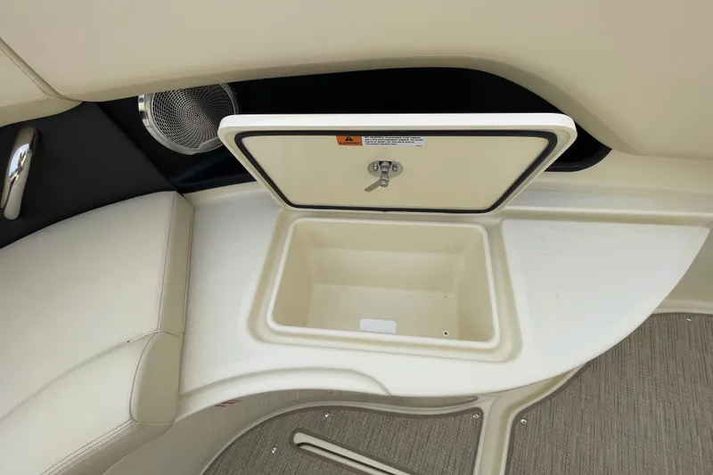 Slide: The Image of 2026 Chris-Craft 310 Catalina storage compartment with beige interior and secure latch. - 70