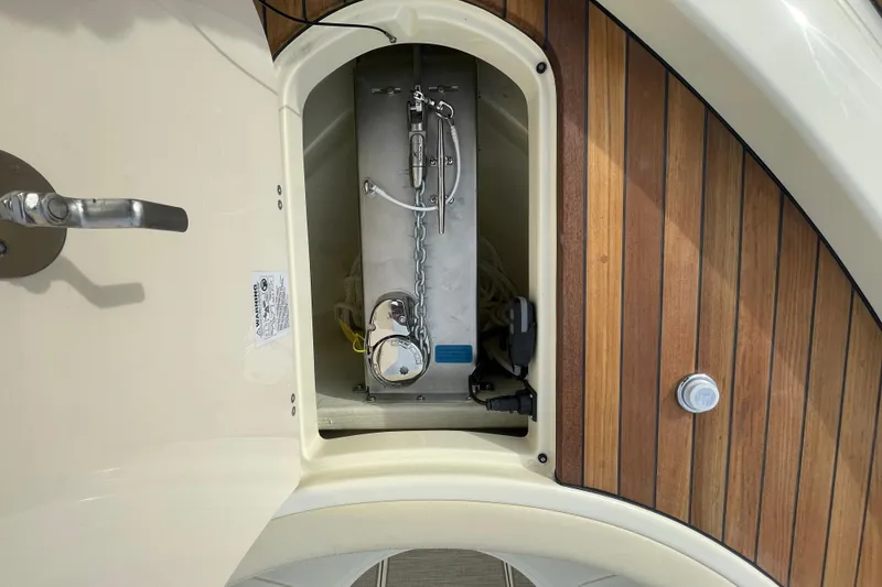 Slide: The Image of 2026 Chris-Craft 310 Catalina anchor compartment with wooden deck detail. - 77