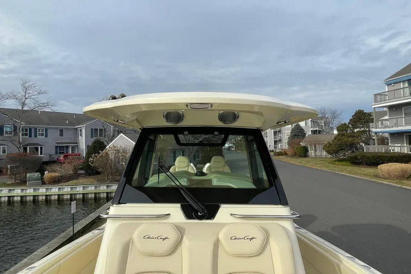 Slide: The Image of 2026 Chris-Craft 310 Catalina boat docked near waterfront homes. - 78