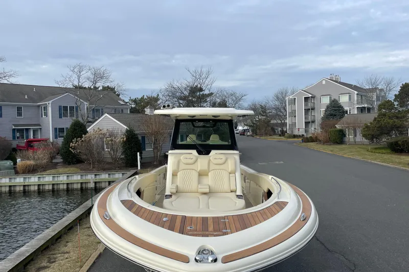 Slide: The Image of 2026 Chris-Craft 310 Catalina boat parked near waterfront homes, showcasing luxury design. - 79