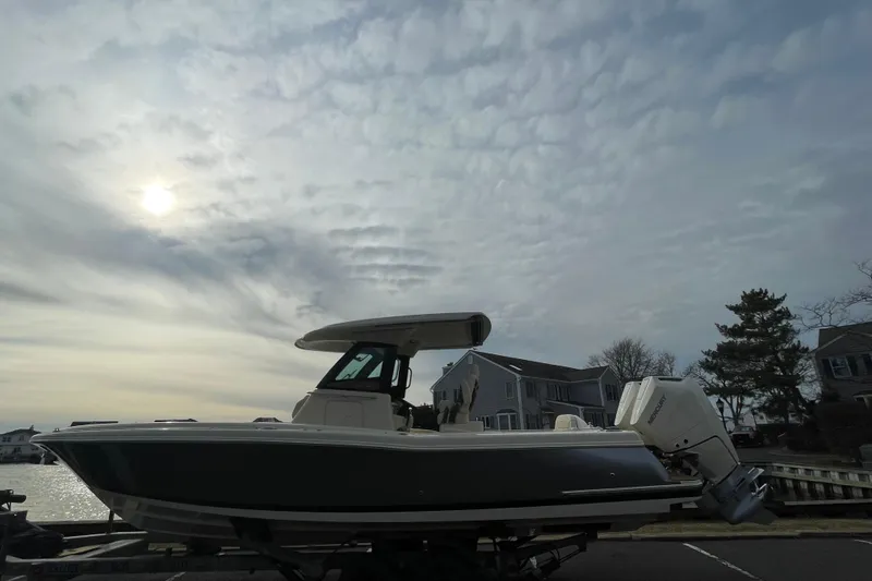 Slide: The Image of 2026 Chris-Craft 310 Catalina boat docked under cloudy sky. - 8