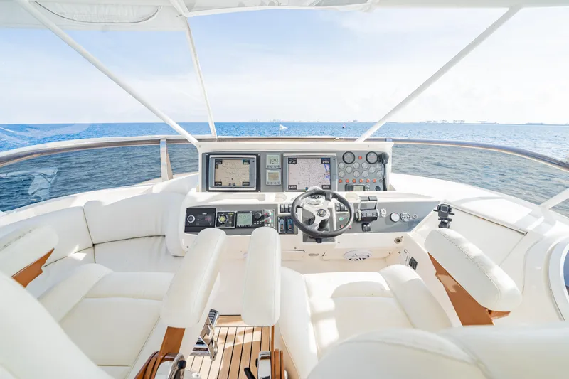 Slide: The Image of 2004 Viking Princess Flybridge yacht helm with ocean view, featuring modern navigation equipment. - 13