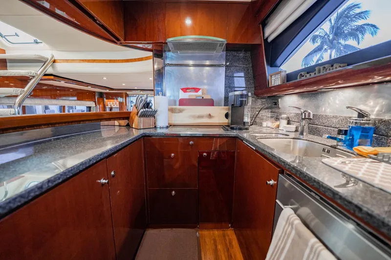 Slide: The Image of Luxurious 2004 Viking Princess Flybridge yacht kitchen with modern amenities and sleek design. - 25