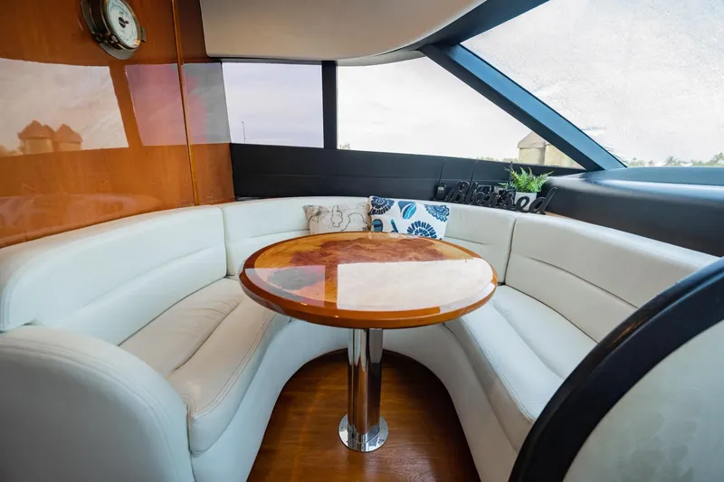 Slide: The Image of Luxurious 2004 Viking Princess Flybridge yacht interior with elegant seating and wooden table. - 28