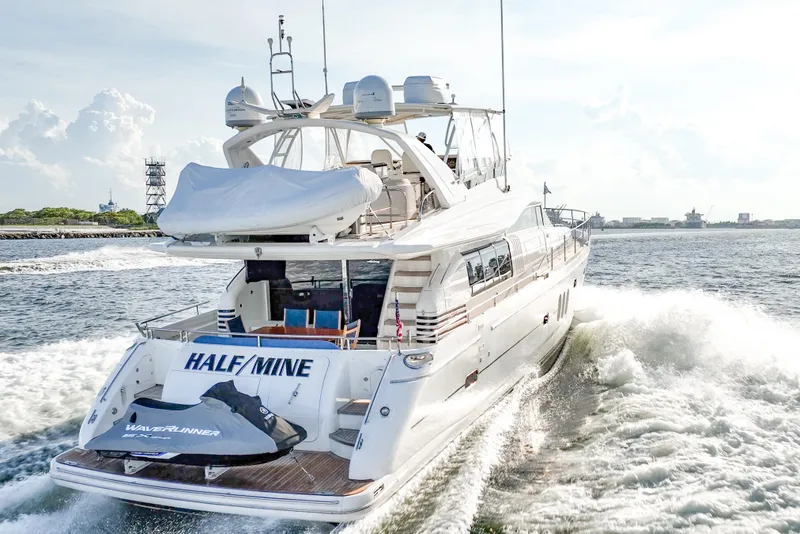 Slide: The Image of 2004 Viking Princess Flybridge yacht cruising on open water, rear view. - 3