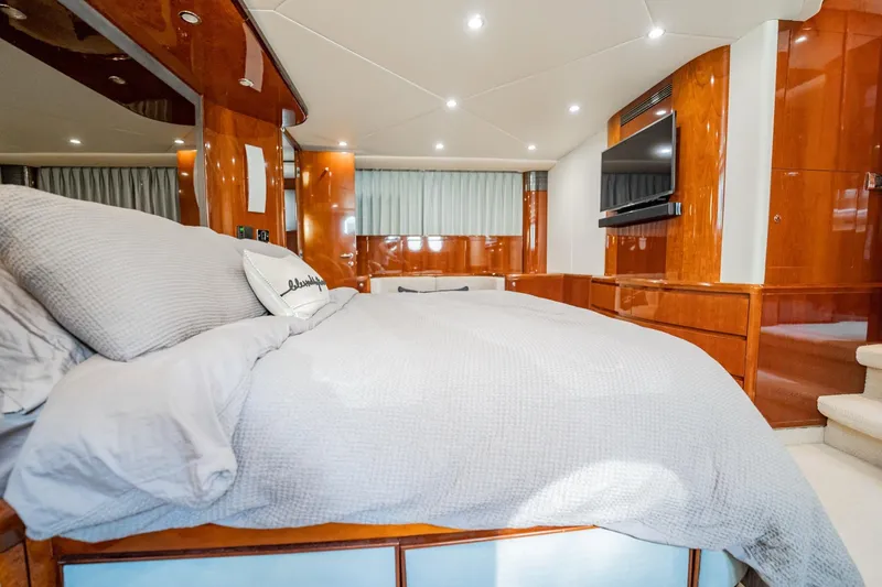 Slide: The Image of Luxurious 2004 Viking Princess Flybridge yacht bedroom with elegant wood finishes and modern amenities. - 34