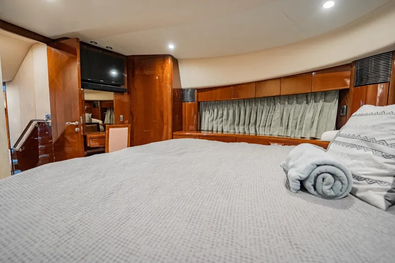 Slide: The Image of Luxurious 2004 Viking Princess Flybridge yacht bedroom with elegant wood finishes. - 37