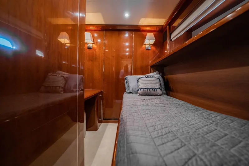 Slide: The Image of Luxurious 2004 Viking Princess Flybridge cabin with elegant wood finish and cozy bedding. - 43