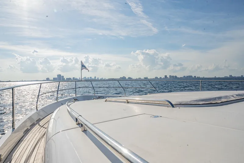 Slide: The Image of 2004 Viking Princess Flybridge yacht cruising with city skyline in the background. - 5