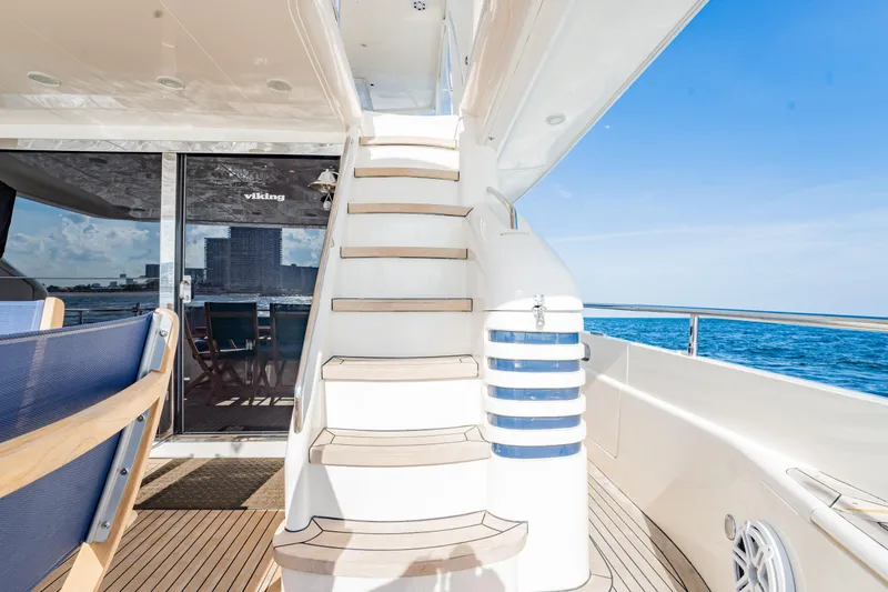 Slide: The Image of 2004 Viking Princess Flybridge yacht with elegant staircase and ocean view. - 6