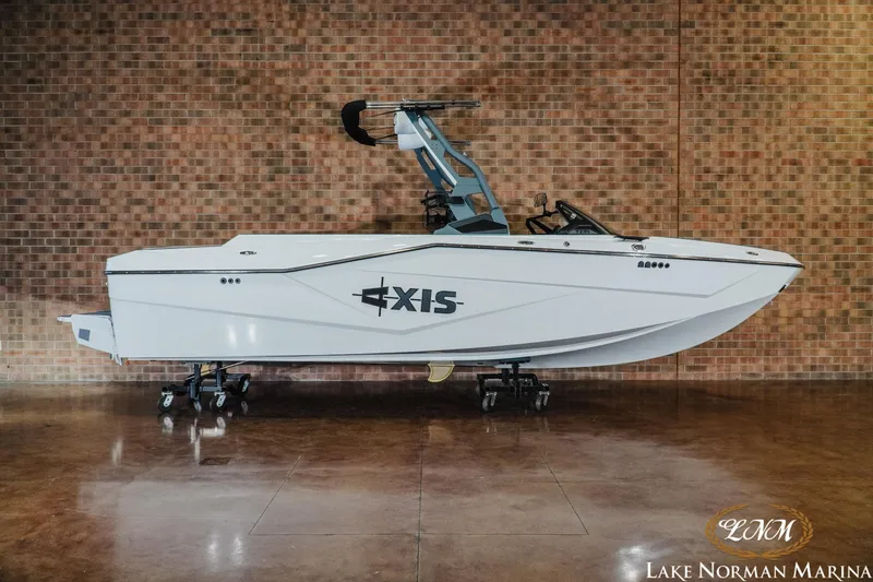 The Image of 2026 Axis T235 boat displayed at Lake Norman Marina, against a brick wall backdrop. - 0