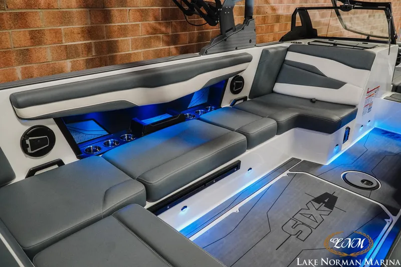 Slide: The Image of Luxurious interior of 2026 Axis T235 boat with blue LED lighting and comfortable seating. - 11