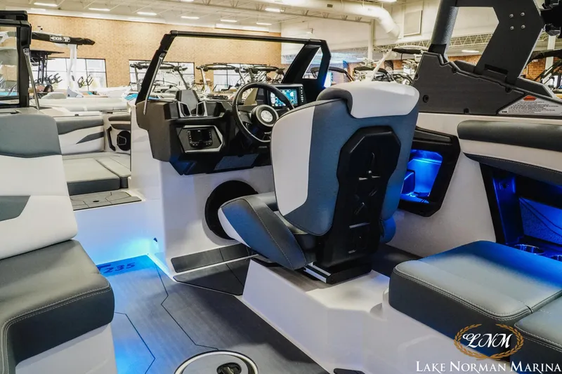 Slide: The Image of 2026 Axis T235 boat interior with modern seating and illuminated dashboard at Lake Norman Marina. - 12