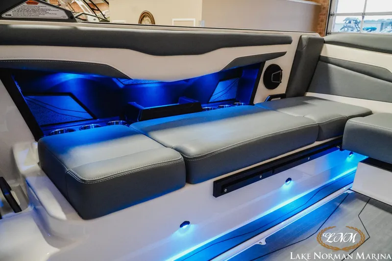 Slide: The Image of 2026 Axis T235 boat interior with blue LED lighting and cushioned seating at Lake Norman Marina. - 13