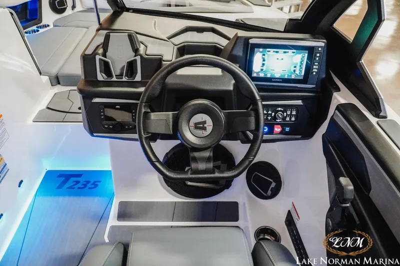 Slide: The Image of 2026 Axis T235 boat dashboard with steering wheel and digital display at Lake Norman Marina. - 15