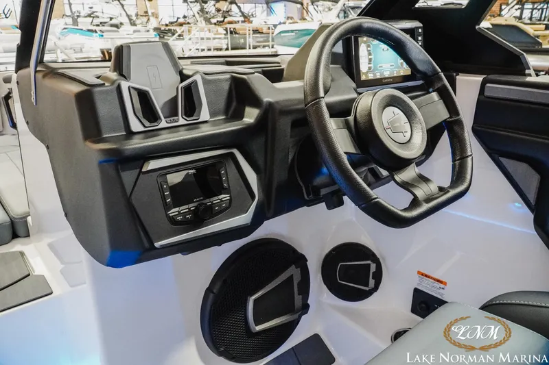 Slide: The Image of 2026 Axis T235 boat dashboard with steering wheel and control panel at Lake Norman Marina. - 17