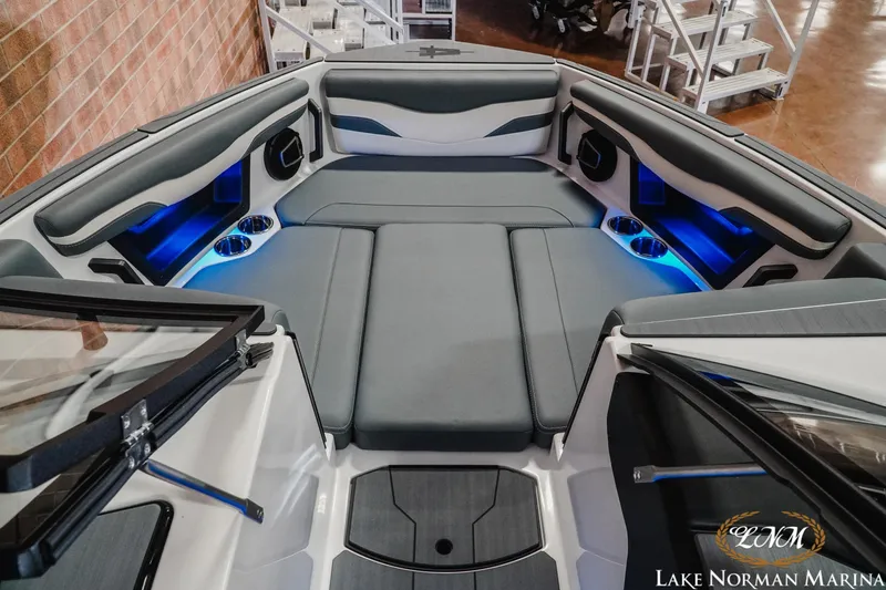 Slide: The Image of 2026 Axis T235 boat interior with blue LED lighting and cushioned seating at Lake Norman Marina. - 18