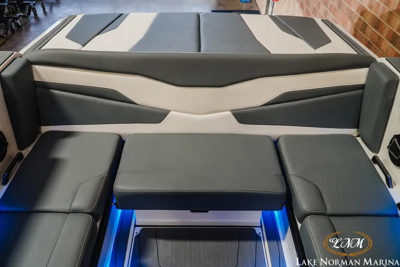 Slide: The Image of 2026 Axis T235 boat interior with sleek seating and ambient blue lighting at Lake Norman Marina. - 22