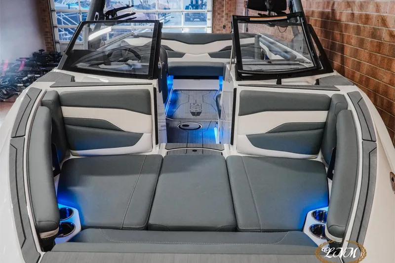 Slide: The Image of 2026 Axis T235 boat interior with gray seating, blue LED lighting, and modern design. - 4