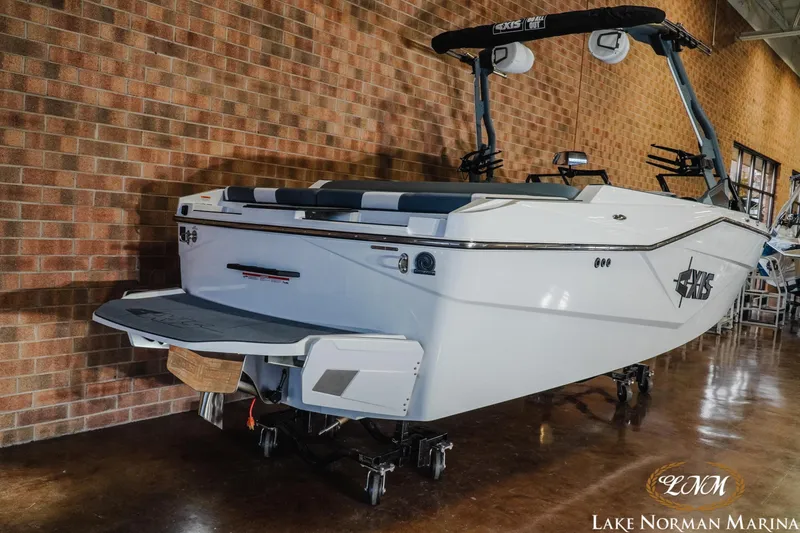 Slide: The Image of 2026 Axis T235 boat displayed indoors at Lake Norman Marina. - 6