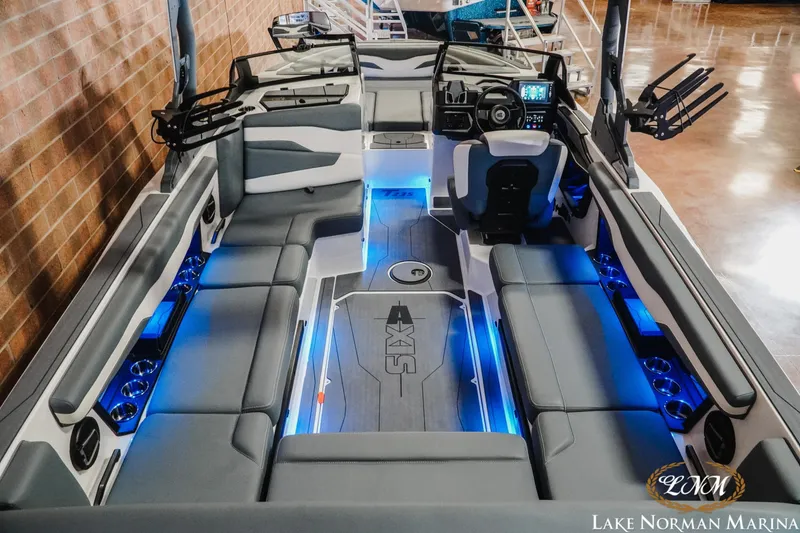 Slide: The Image of 2026 Axis T235 boat interior with blue LED lighting and spacious seating at Lake Norman Marina. - 9