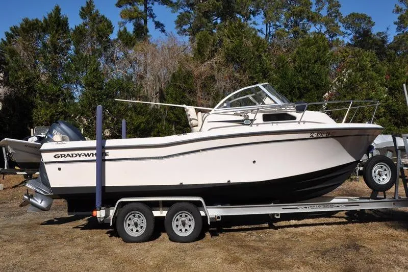 The Image of 2007 Grady-White Seafarer 226 boat on trailer, parked outdoors. - 1