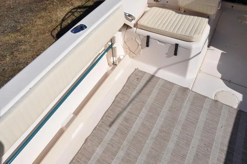 Slide: The Image of 2007 Grady-White Seafarer 226 boat interior with seating and striped carpet. - 10