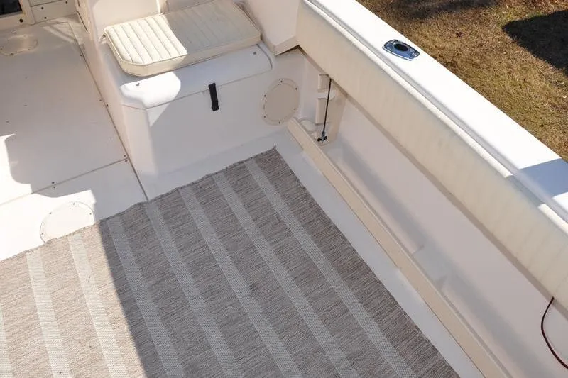 Slide: The Image of 2007 Grady-White Seafarer 226 boat interior with seating and striped rug. - 11
