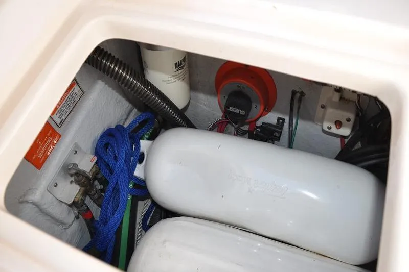 Slide: The Image of Storage compartment of 2007 Grady-White Seafarer 226 boat with ropes and equipment. - 15