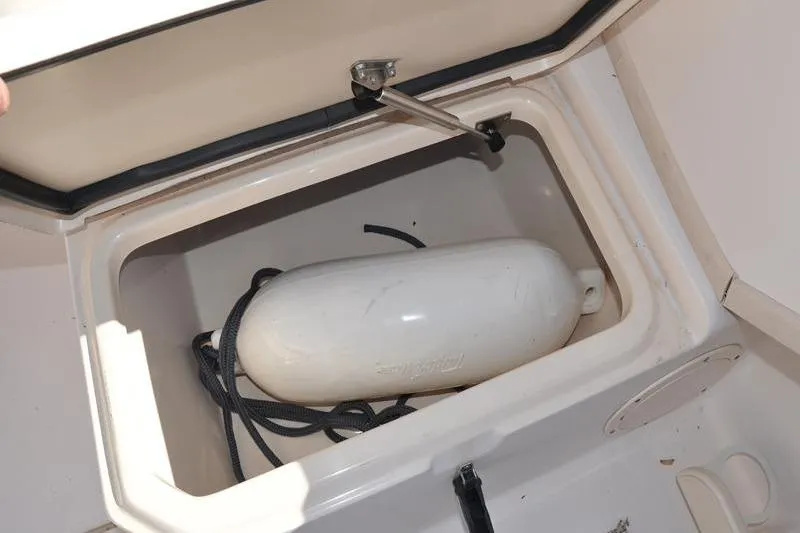 Slide: The Image of Storage compartment on a 2007 Grady-White Seafarer 226 boat with a white fender. - 17