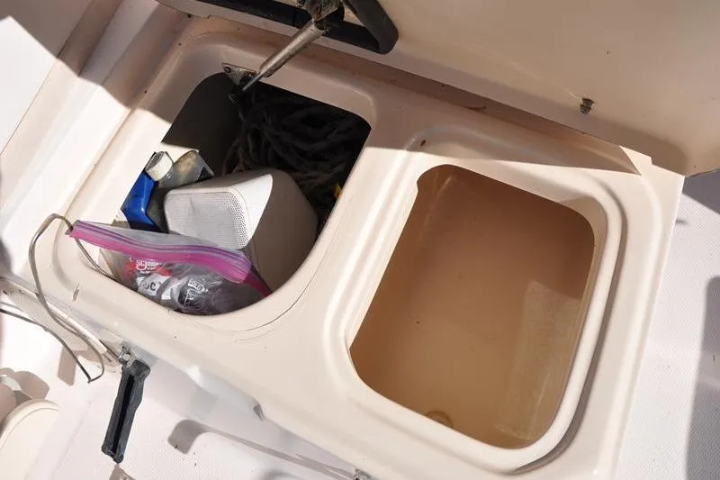 Slide: The Image of Storage compartments on a 2007 Grady-White Seafarer 226 boat, containing various items. - 18