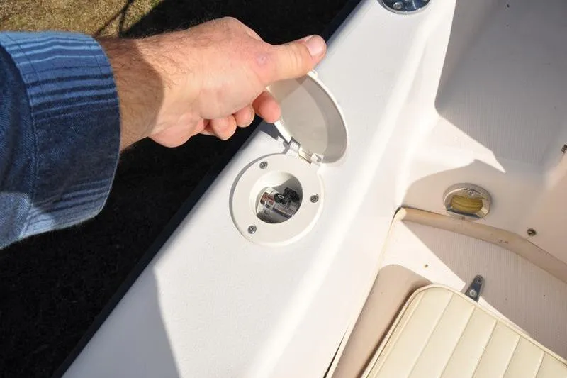 Slide: The Image of Hand opening fuel cap on 2007 Grady-White Seafarer 226 boat deck. - 19