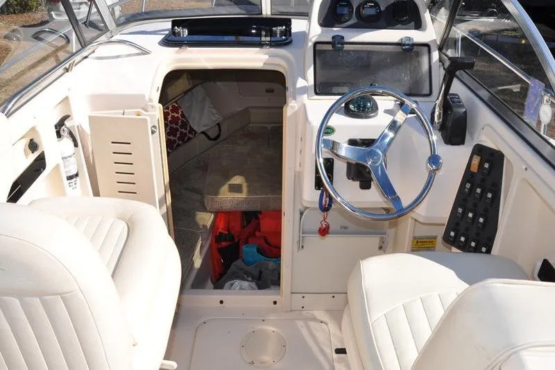 Slide: The Image of 2007 Grady-White Seafarer 226 boat interior with steering wheel and cabin view. - 20