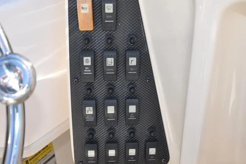 Slide: The Image of Control panel of 2007 Grady-White Seafarer 226 boat with various switches. - 27