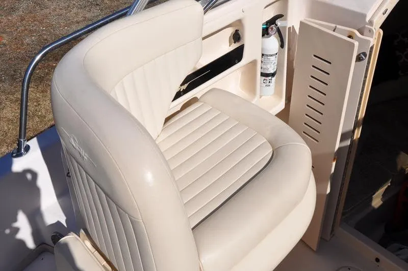 Slide: The Image of 2007 Grady-White Seafarer 226 boat seat with beige upholstery and safety equipment. - 31